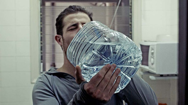 A Man Drinking A Gallon of Water to Stay Hydrated