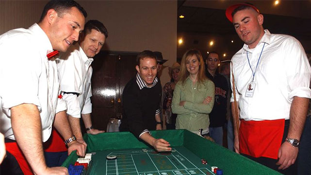 Craps Dealer Looking on as a Player Roles