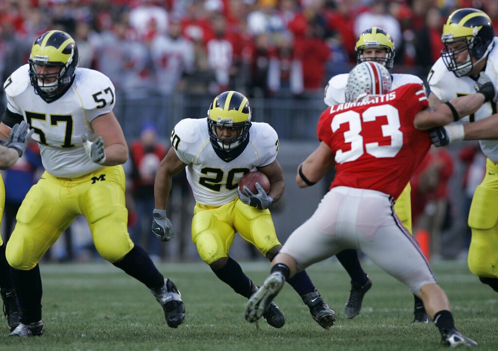 Michigan running back Mike Hart (20) runs against Ohio State defense Saturday, Nov. 18, 2006 during a college football game in Columbus, Ohio. (AP Photo/Kiichiro Sato)