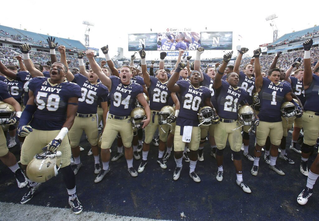 Navy players celebrate after defeating Notre Dame 28-27 in an NCAA college football game Saturday, Nov. 5, 2016, in Jacksonville, Fla. (AP Photo/John Raoux)