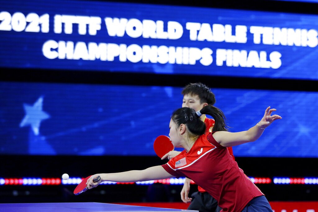 Lily Zhang returns a volley in front of teammate Lin Gaoyuan during a mixed doubles match during the third day of the 2021 World Table Tennis Championships Thursday, Nov. 25, 2021, in Houston. (AP Photo/Michael Wyke)