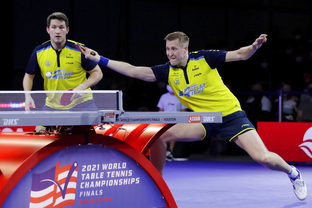 Sweden's Kristian Karlsson, left, looks on as Mattias Falck, right, returns a volley during the men's doubles finals match against South Korea during day seven of the 2021 World Table Tennis Championships Monday, Nov. 29, 2021, in Houston. (AP Photo/Michael Wyke)