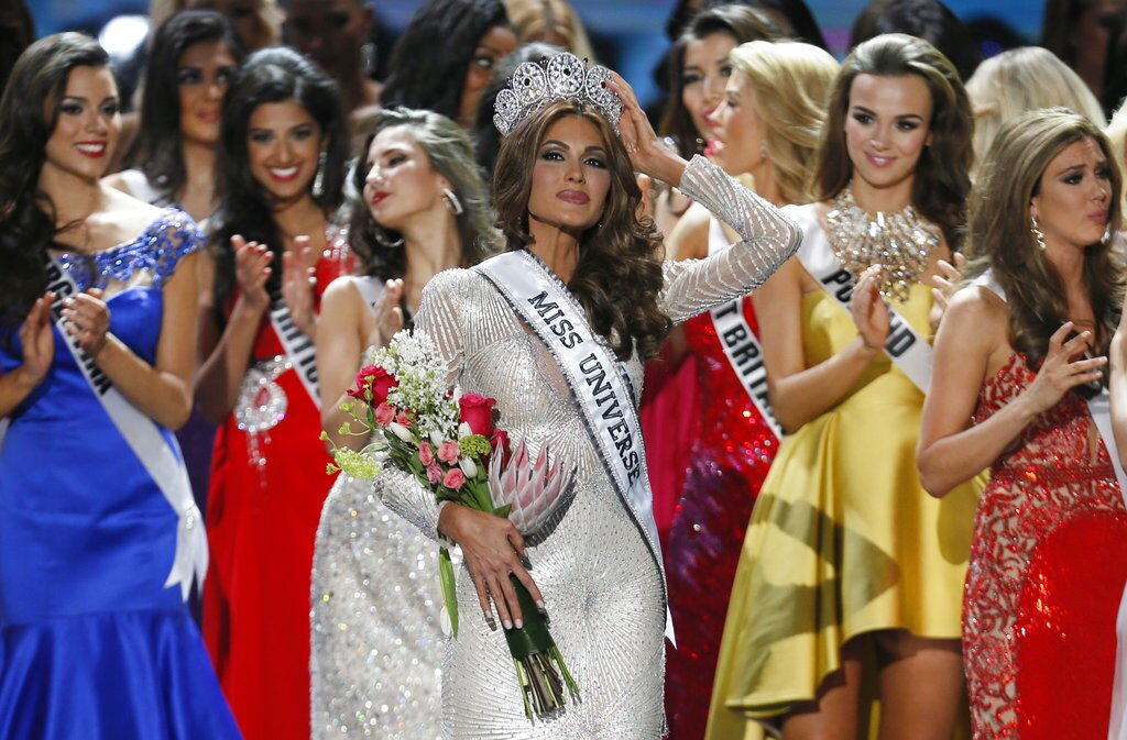 FILE - In this Nov. 9, 2013 file photo, Miss Universe Gabriela Isler, from Venezuela, adjusts her crown after winning the crown in Moscow, Russia. Venezuela has seven Miss Universe crowns and is the second country with the most beauty queens behind the United States. (AP Photo/Pavel Golovkin, File)