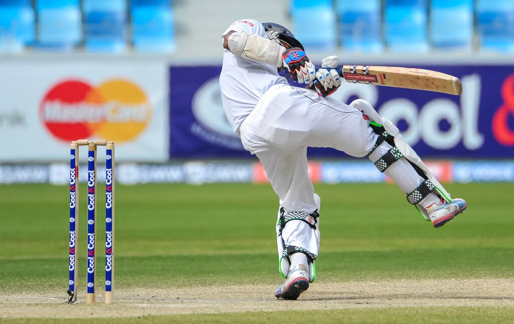 Dimuth Karunaratne of Sri Lanka doges a wild ball from Pakistan bowler Junaid Khan during the second cricket test match between Pakistan and Sri Lanka at the Dubai International Cricket Stadium in Dubai, United Arab Emirates, on Sunday, Jan. 12, 2014. (AP Photo/Stephen Hindley)