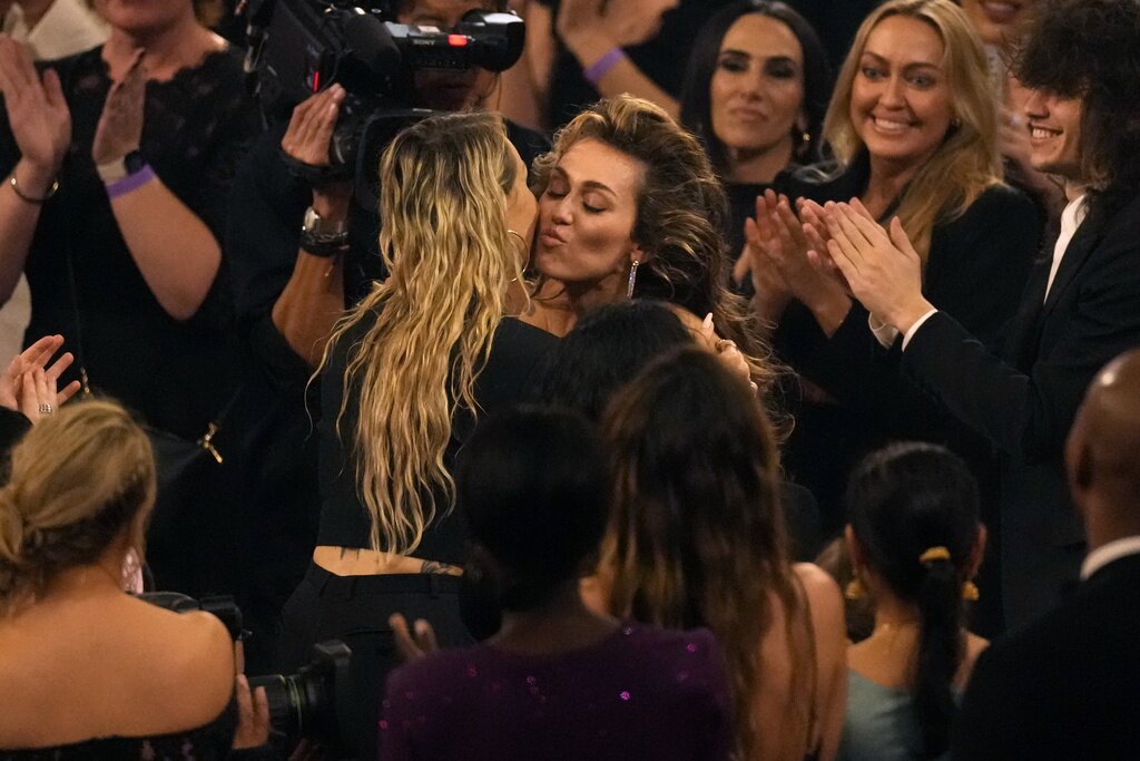 Tish Cyrus, left, and Miley Cyrus embrace after Miley Cyrus wins the award for record of the year for "Flowers" during the 66th annual Grammy Awards on Sunday, Feb. 4, 2024, in Los Angeles. (AP Photo/Chris Pizzello)