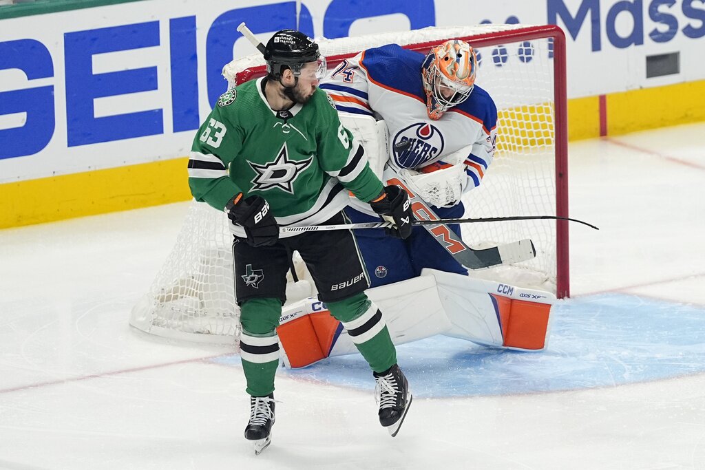 Edmonton Oilers goaltender Stuart Skinner blocks a shot under pressure from Dallas Stars right wing Evgenii Dadonov (63) during the third period of Game 5 of the Western Conference finals in the NHL hockey Stanley Cup playoffs Friday, May 31, 2024, in Dallas. (AP Photo/Julio Cortez)