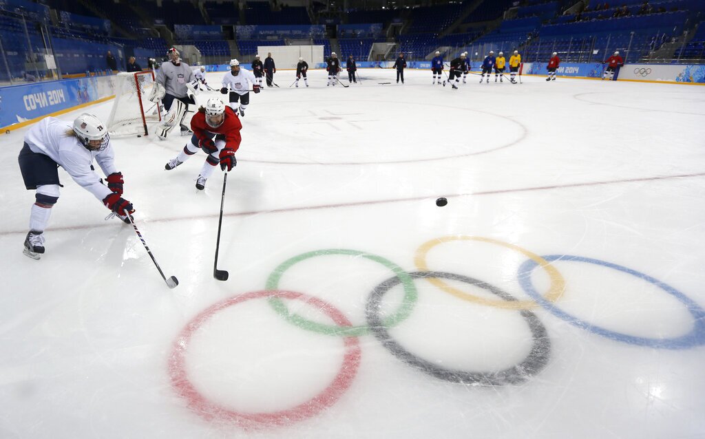 Meghan Duggan, right, of the U.S. women's ice hockey team challenges her teammate Amanda Kessel, left, during their practice session ahead of the 2014 Winter Olympics, Thursday, Feb. 6, 2014, in Sochi, Russia. (AP Photo/Petr David Josek)