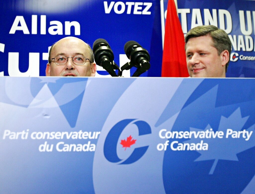 Conservative Leader Stephen Harper (right) listens to candidate Alan Cutler (left) during the opening of Cutler's campaign office in Ottawa Monday, Dec. 5, 2005. Canadians will go to the polls Jan. 23, 2006.(CP PHOTO/Jonathan Hayward)