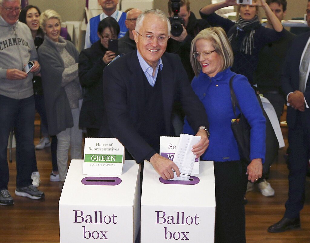 Australian Prime Minister Malcolm Turnbull, center left, and wife Lucy cast their votes in the federal election at the Double Bay public school in Sydney, Australia, Saturday, July 2, 2016. After years of political turmoil, Australians headed to the polls on Saturday with leaders of the nation's major parties each promising to bring stability to a government that has long been mired in chaos. (AP Photo/Rob Griffith)